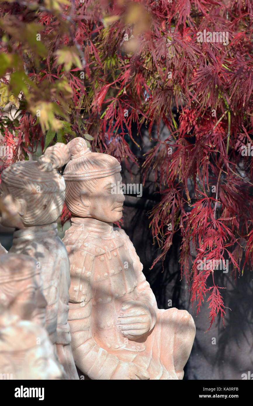 Japanese acer trees and oriental stone ornaments for sale at a garden