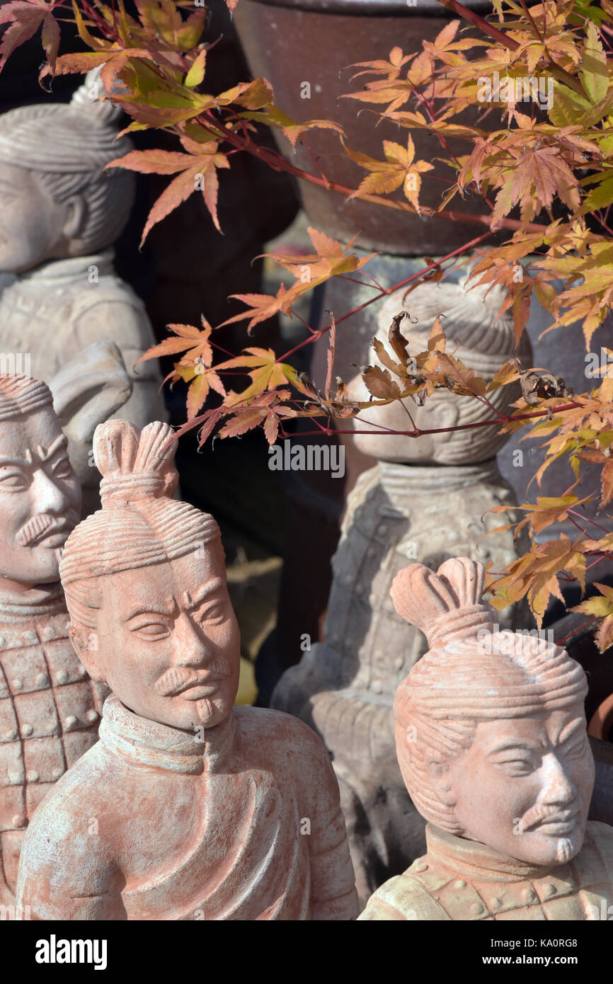 Japanese acer trees and oriental stone ornaments for sale at a garden
