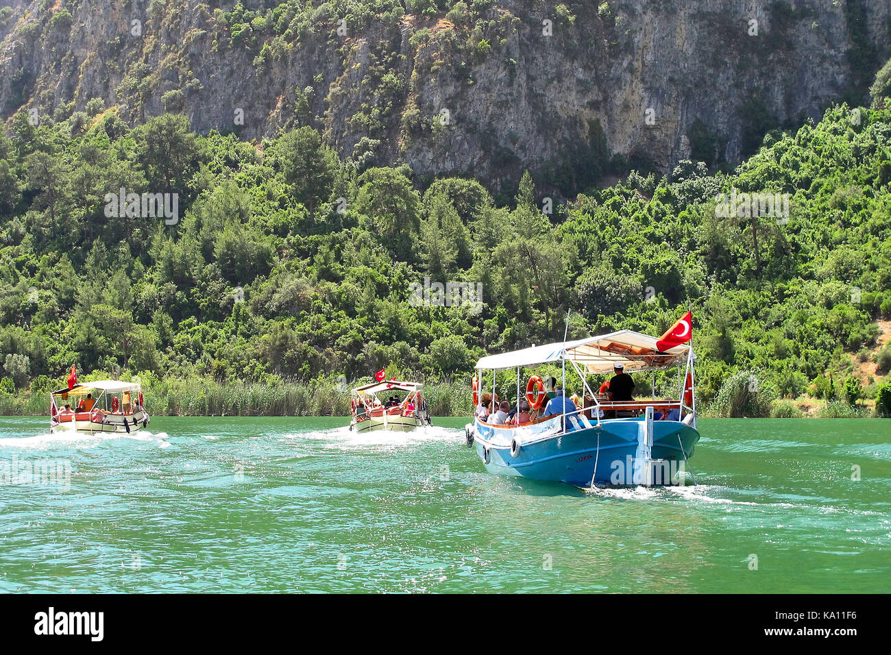 Tourists river boats along the Dalyan River, Turkey Stock Photo