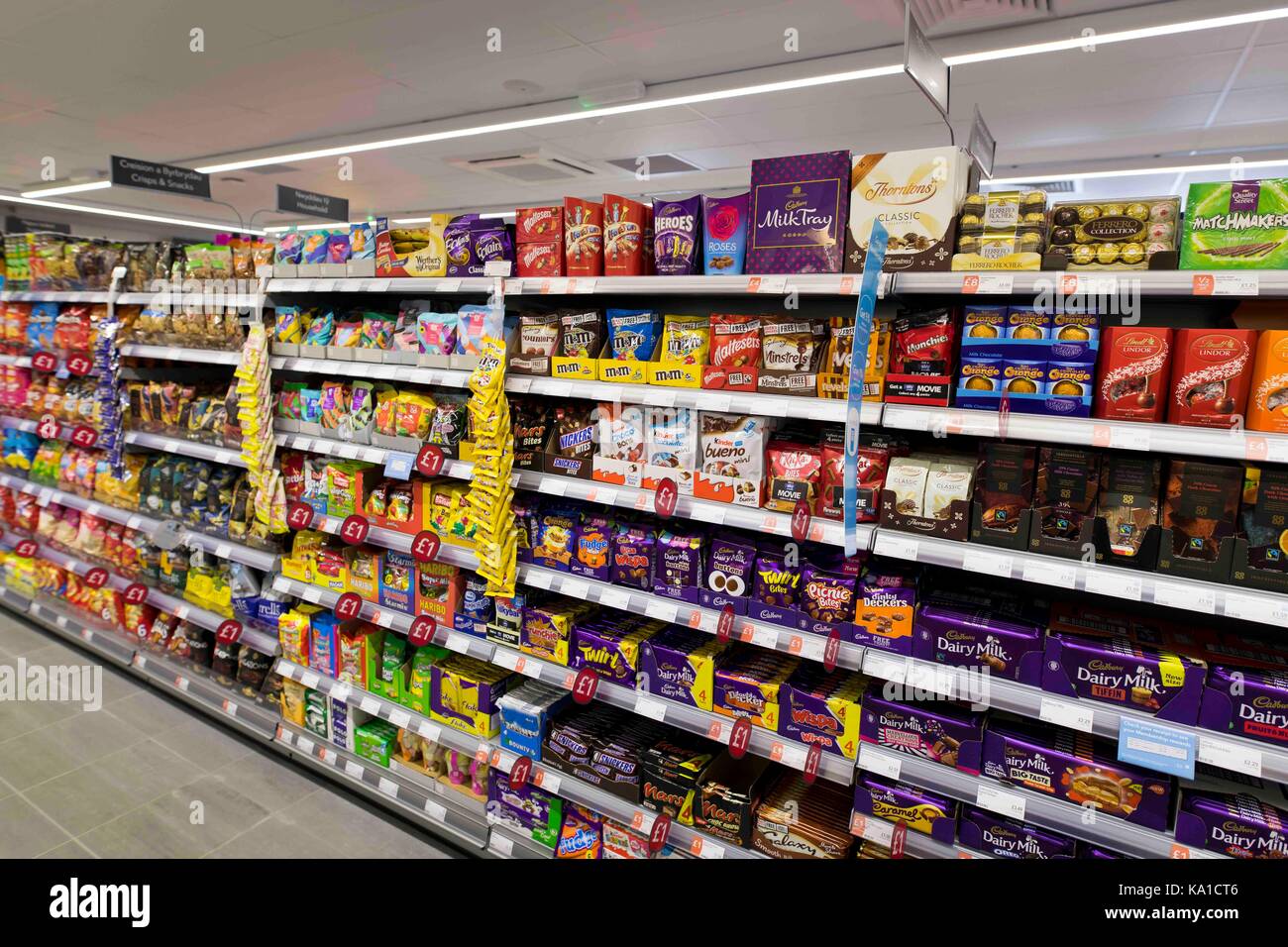 Chocolates and snacks on display in a supermarket shop Stock Photo Alamy