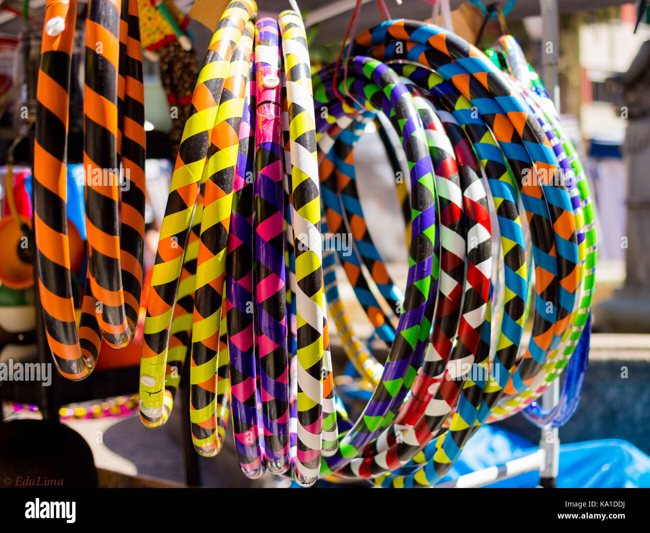 colorful hula hoops hanging on a art craft stand market in Rio de Janeiro, Brazil on sale for kids and adults Stock Photo