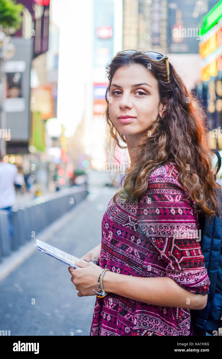 Female tourist with a map at Times Square in New York, USA Stock Photo