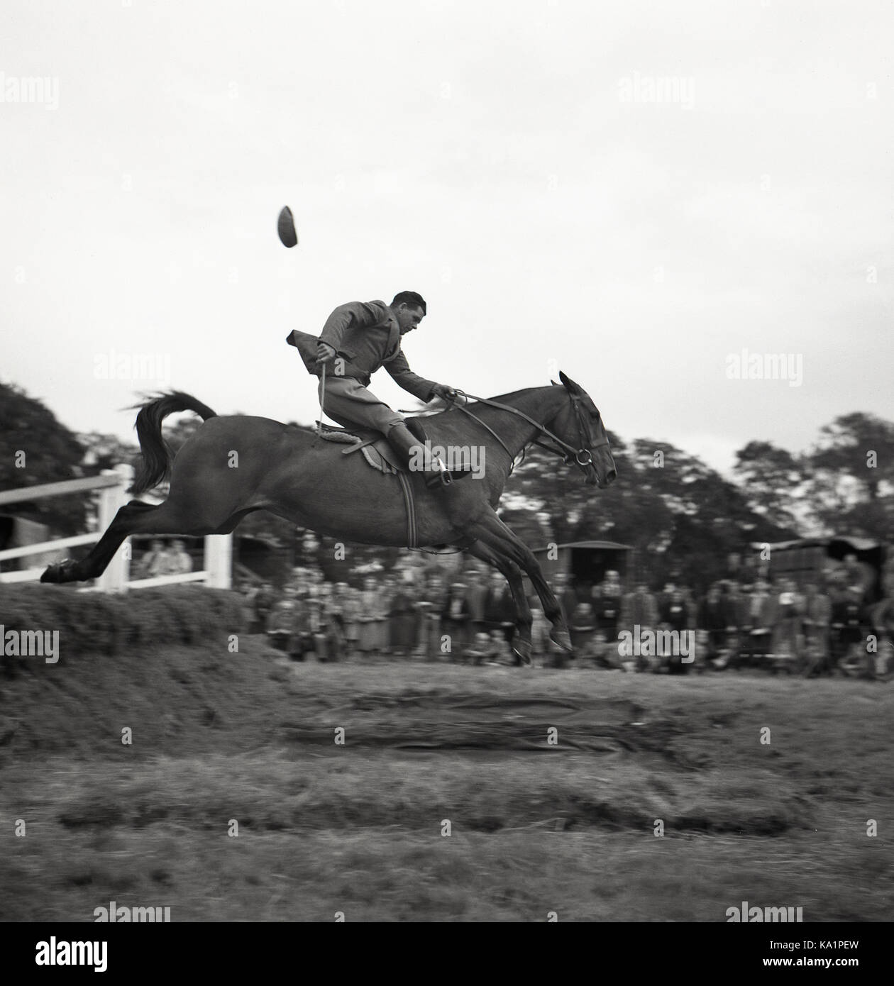 1950s, historical, outdoor eventing competition, a male rider on his horse jumping over a water
