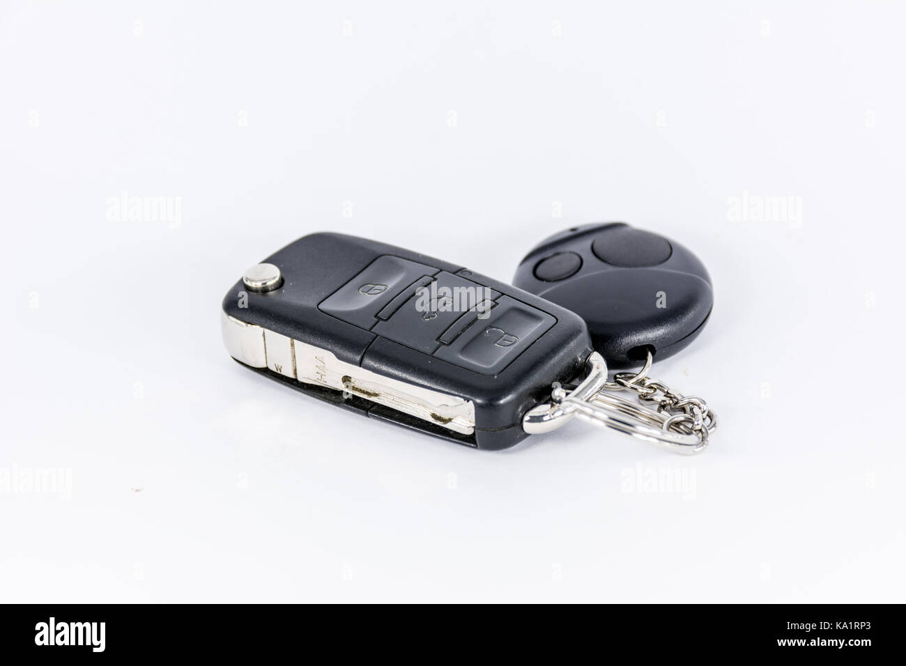 Used car keys black color with remote control on white background Stock