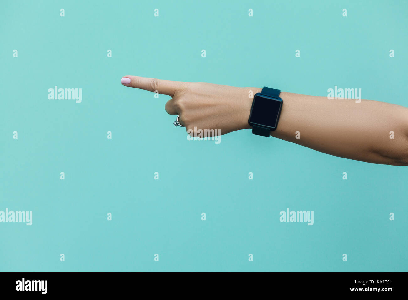 Look this! Hand finger pointing isolated on light blue background. Stock Photo