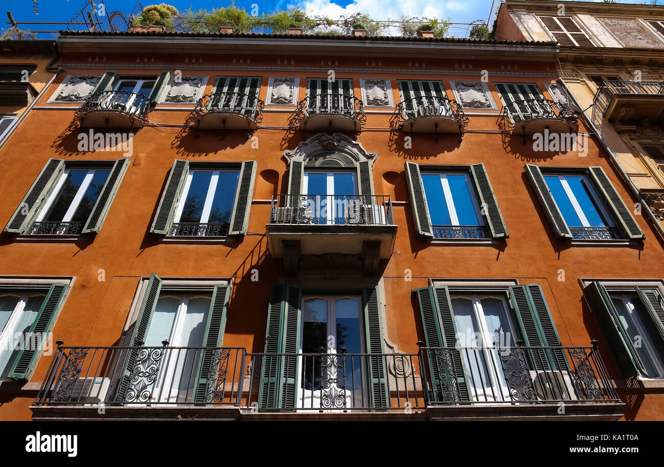 Facade of traditional colorful european italian apartment building in