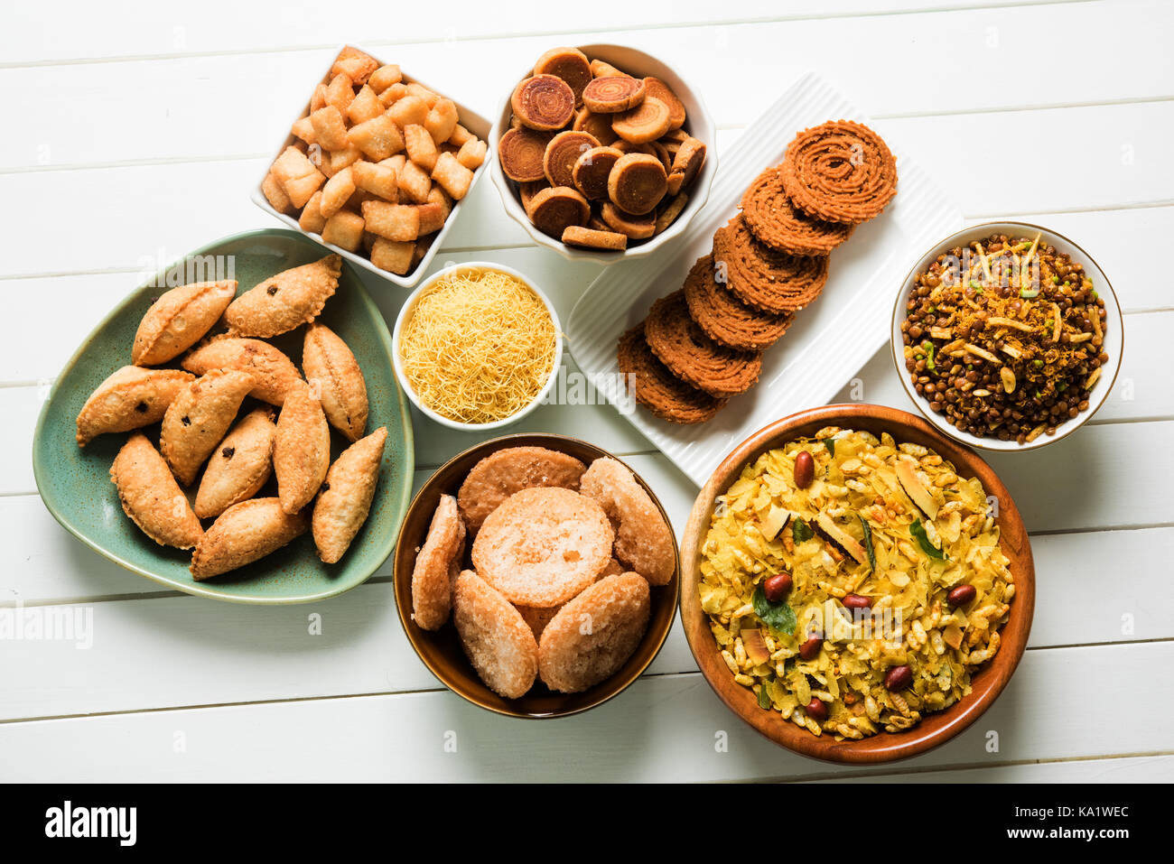 stock photo of  Diwali food or Diwali snacks or Diwali sweets like anarsa, bakarvadi, chakli, sev, bhujiya, shankar pale and chivda or chiwada, karanj Stock Photo