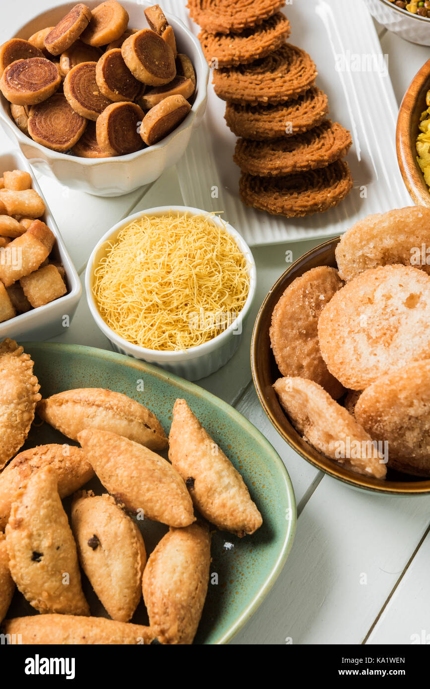 stock photo of  Diwali food or Diwali snacks or Diwali sweets like anarsa, bakarvadi, chakli, sev, bhujiya, shankar pale and chivda or chiwada, karanj Stock Photo