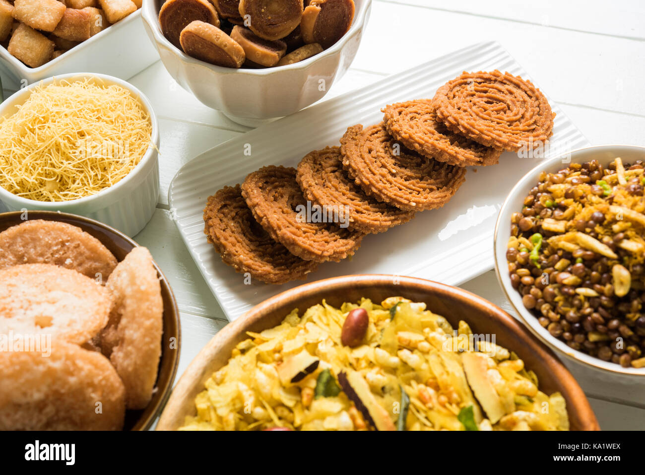 stock photo of  Diwali food or Diwali snacks or Diwali sweets like anarsa, bakarvadi, chakli, sev, bhujiya, shankar pale and chivda or chiwada, karanj Stock Photo