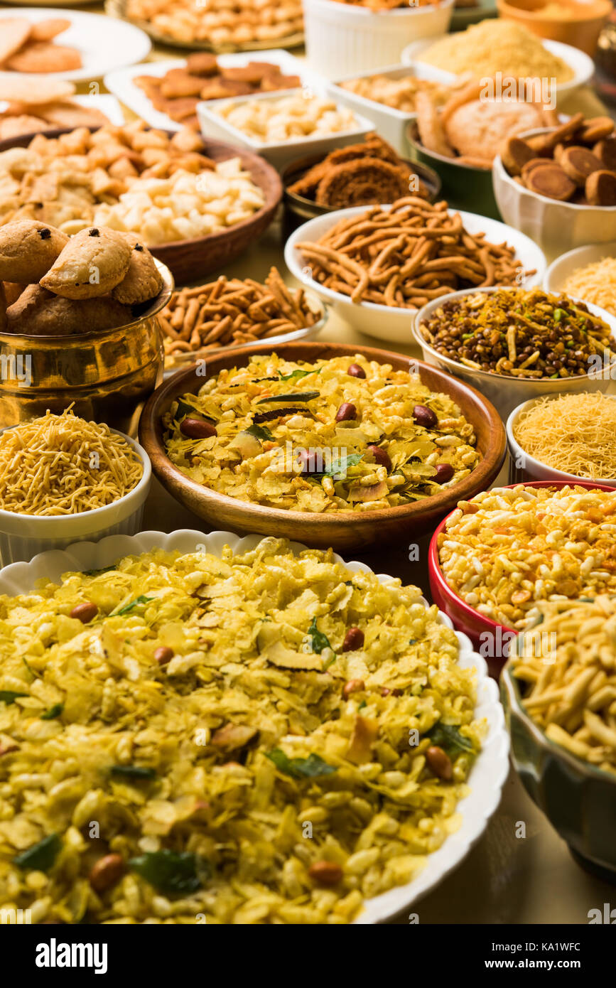 stock photo of  Diwali food or Diwali snacks or Diwali sweets like anarsa, bakarvadi, chakli, sev, bhujiya, shankar pale and chivda or chiwada, karanj Stock Photo