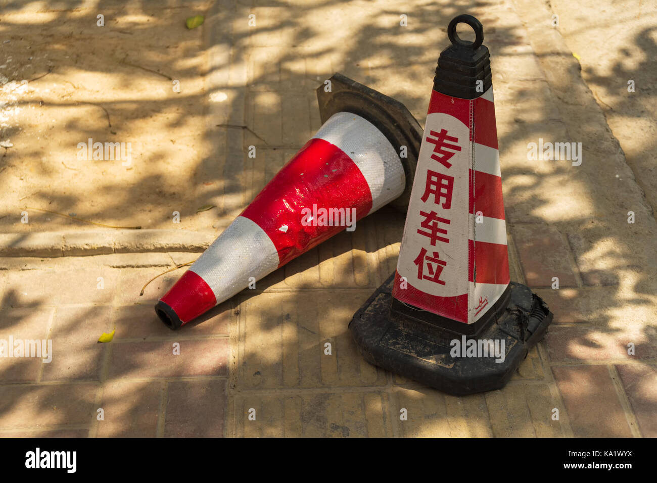 Red signal road cones with inscription in Chinese Stock Photo