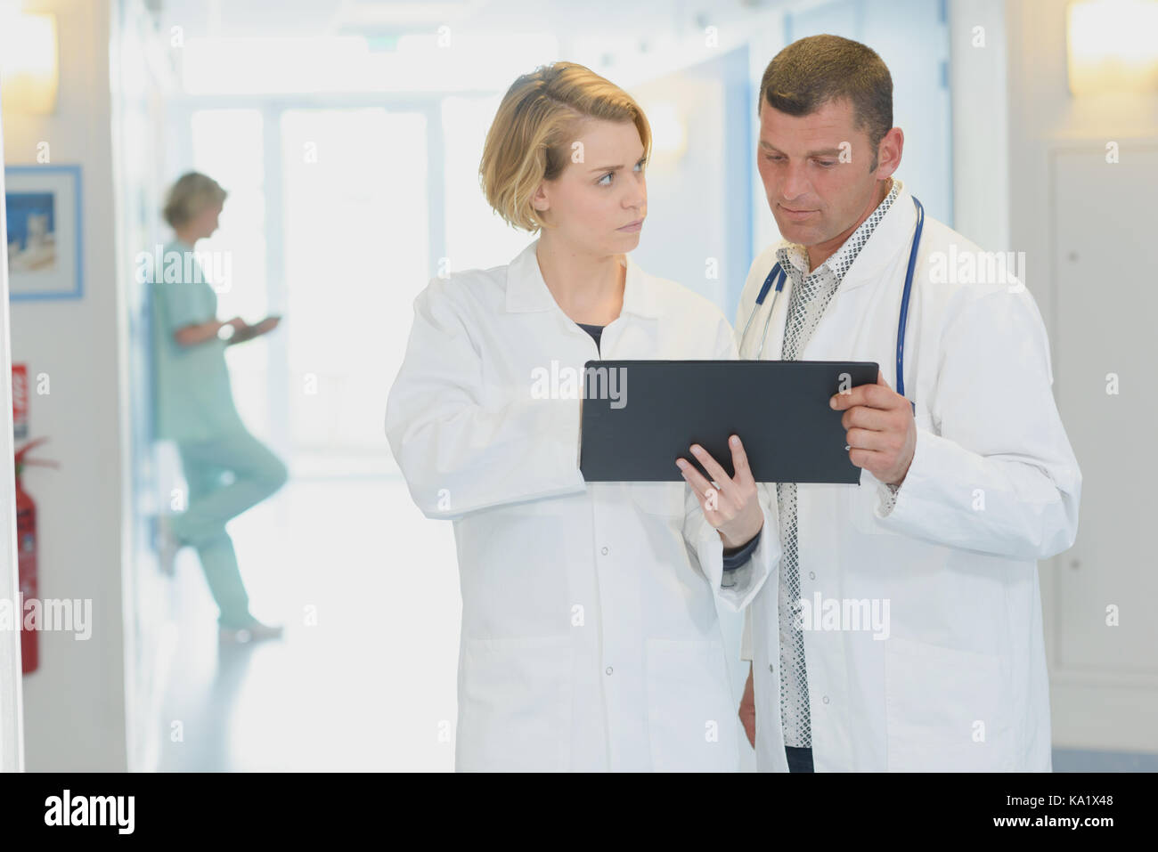 doctors with clipboard and tablet pc computer at hospital corridor Stock Photo