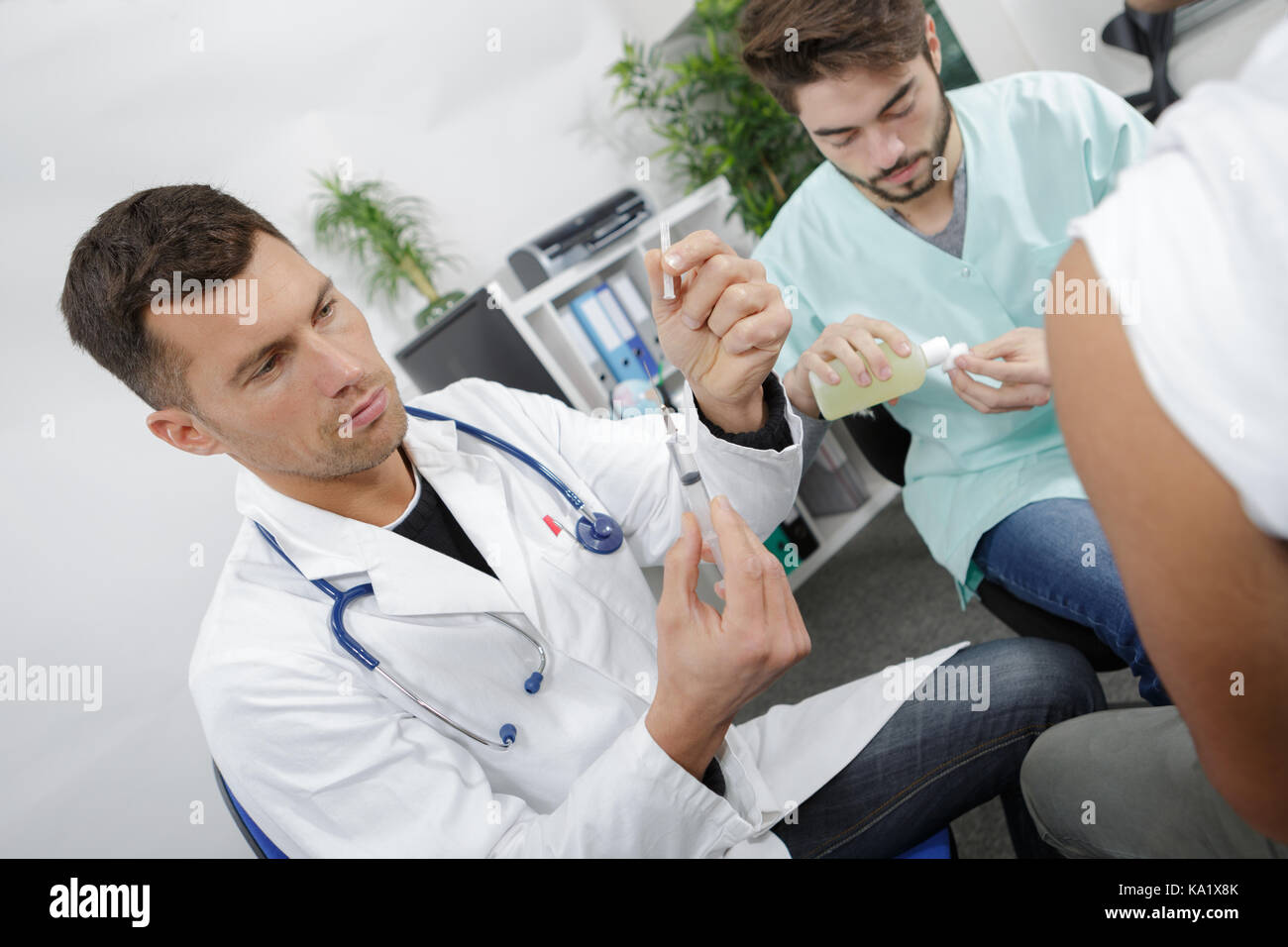 doctor and nurse with syringe is preparing for injection Stock Photo ...