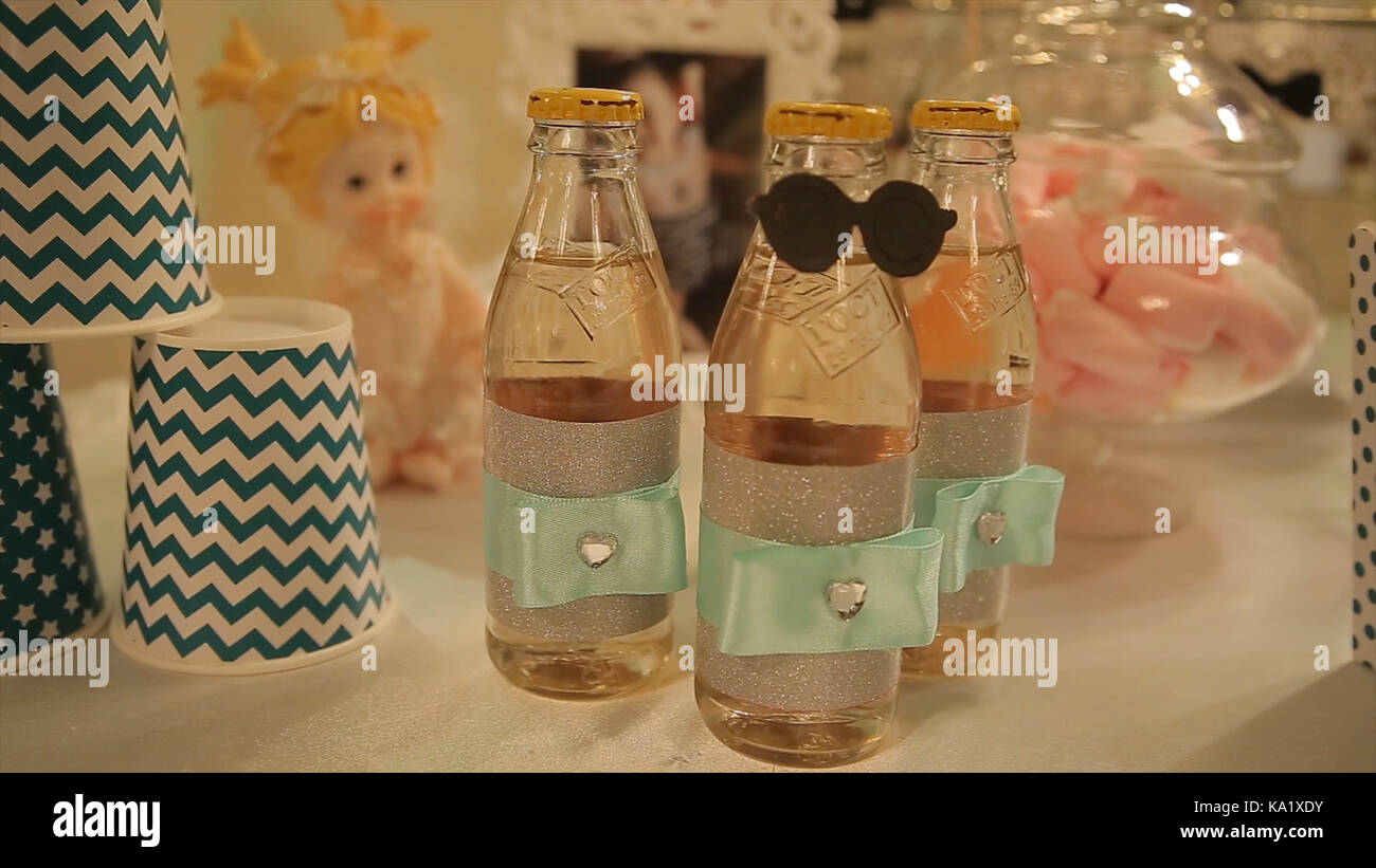 different bottles of juice on the table. Bottled drinks for guests at