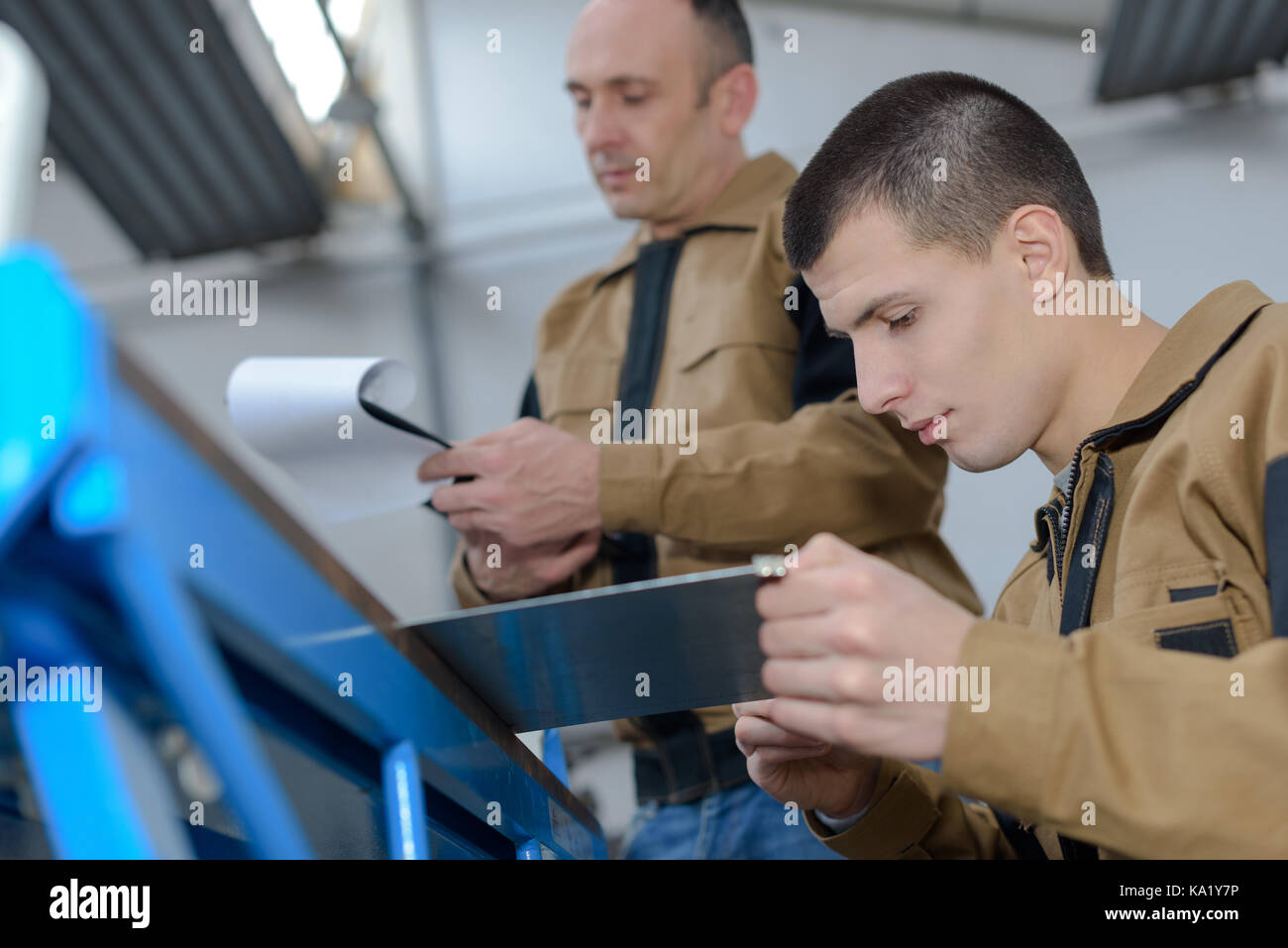Factory Worker With Apprentice Stock Photo Alamy