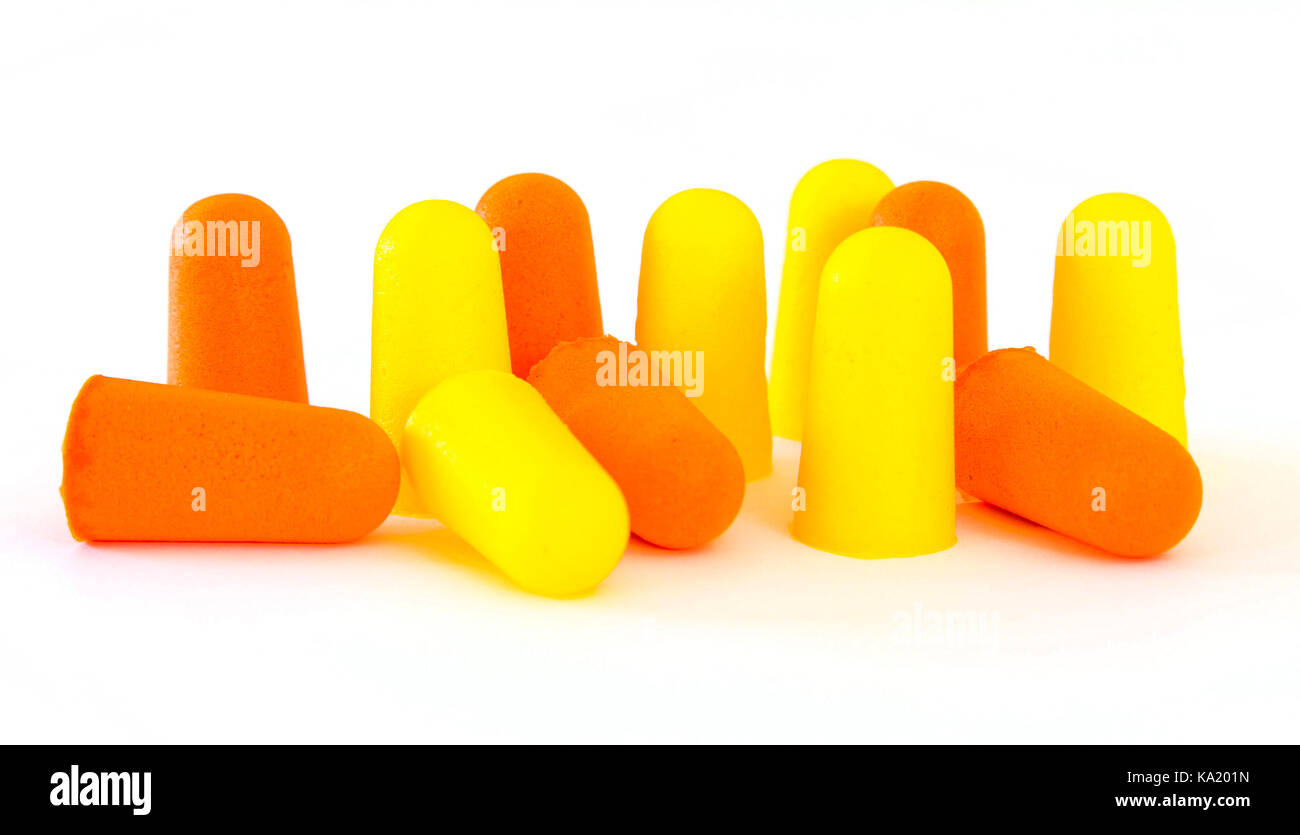 Orange and yellow foam ear plugs isolated on a white background. Studio