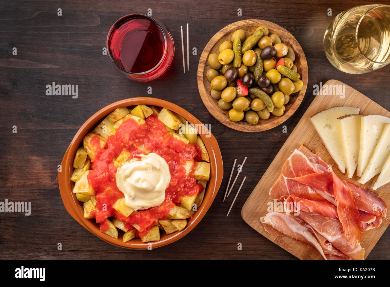 Tapas and wine. Patatas bravas, olives, jamon, cheese Stock Photo