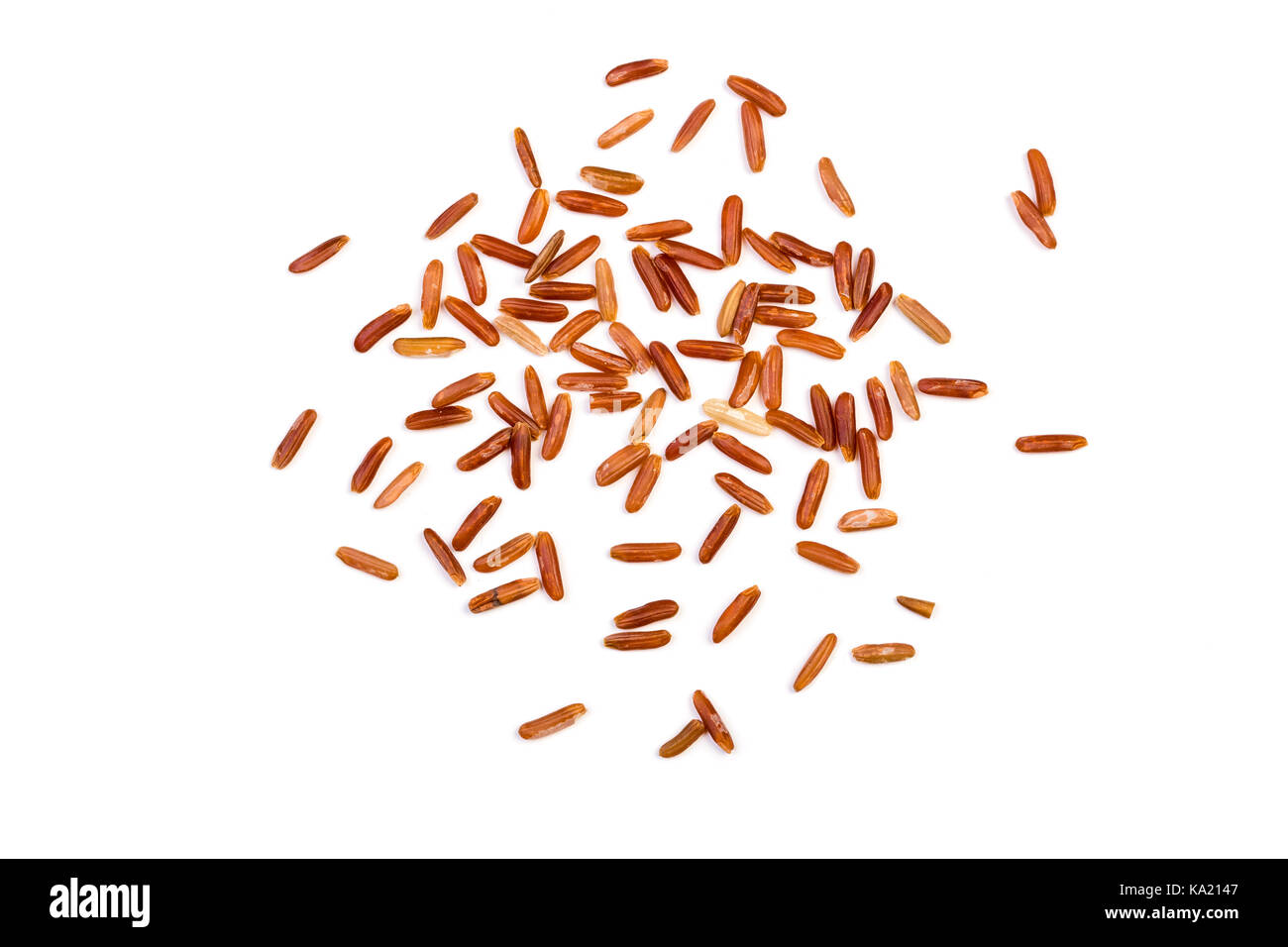 red rice isolated on white scattered around Stock Photo