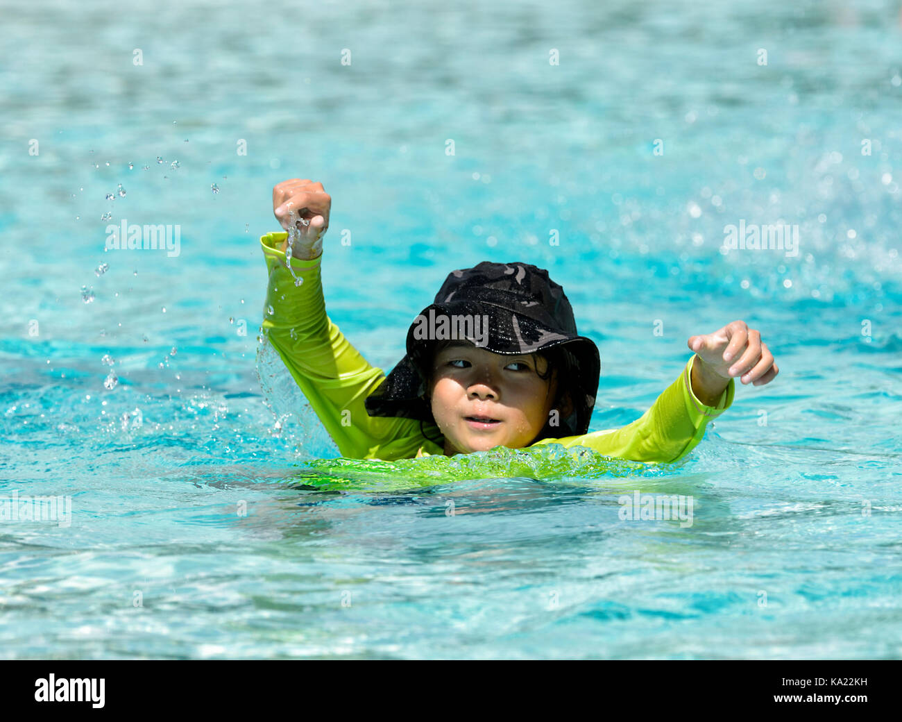 Young Asian boy swimming in the Esplanade Lagoon, Cairns, Far North Queensland, FNQ, QLD, Australia Stock Photo