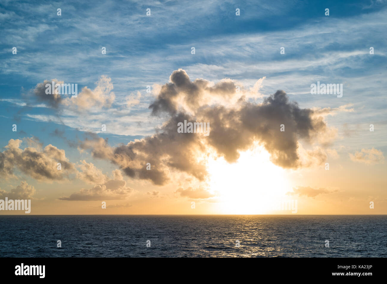 sunset at sea with clouds Stock Photo - Alamy