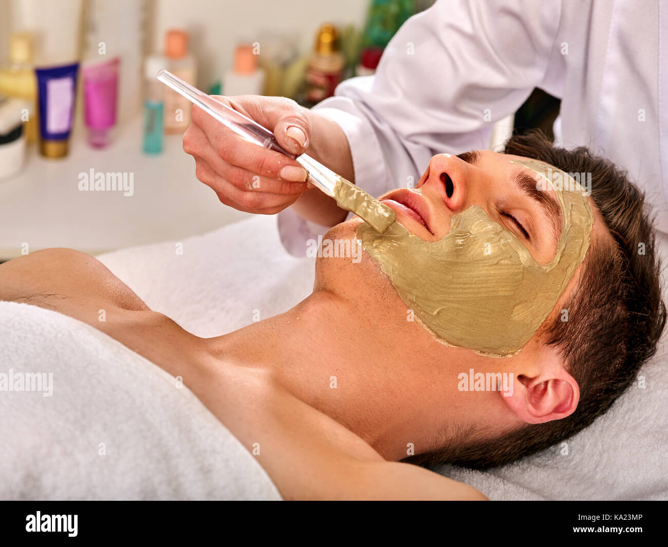 Mud facial mask of woman in spa salon. Face massage Stock Photo - Alamy