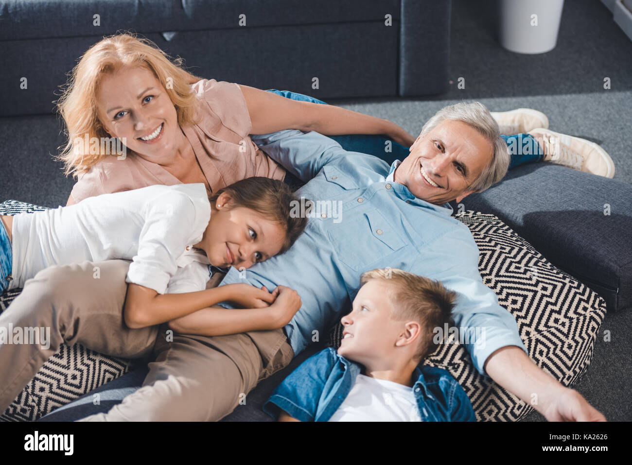 Smiling family lying together hi-res stock photography and images - Alamy