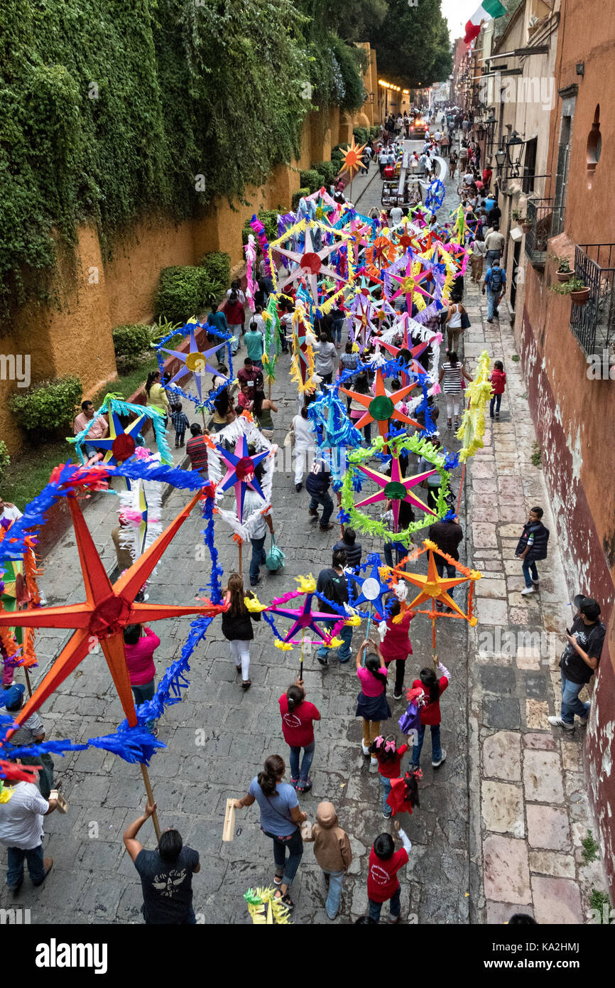 Colorful paper stars march in a fiesta procession through the city at the start of the week long fiesta of the patron saint Saint Michael September 22, 2017 in San Miguel de Allende, Mexico. Stock Photo