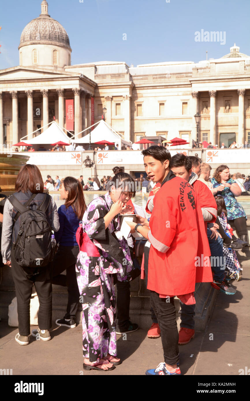London, England. 24 September 2017: Man and Woman in traditional Japanese clothing eating noodles at the Japan Matsuri Festival in Trafalgar Square, London England. Martin Parker/Alamy Live News Stock Photo