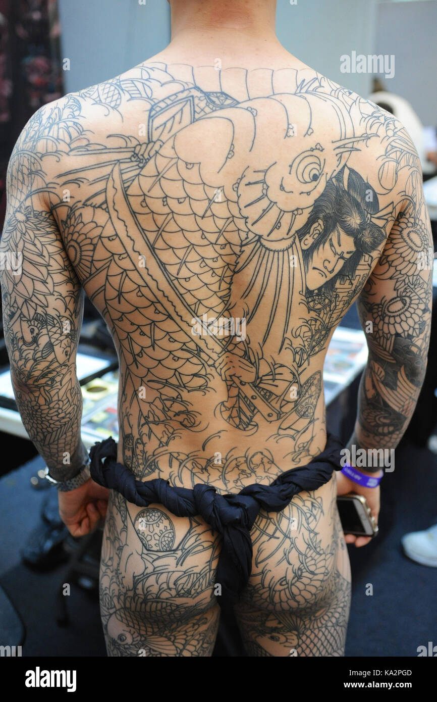 London, UK. 24th September, 2017. A man with a Japanese style body suit  tattoo, before shading and colouring has been completed, at the 13th London  International Tattoo Convention, which took place over