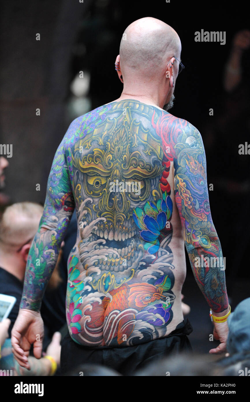 London, UK. 24th September, 2017. A man with a Japanese style body suit  tattoo, before shading and colouring has been completed, at the 13th London  International Tattoo Convention, which took place over