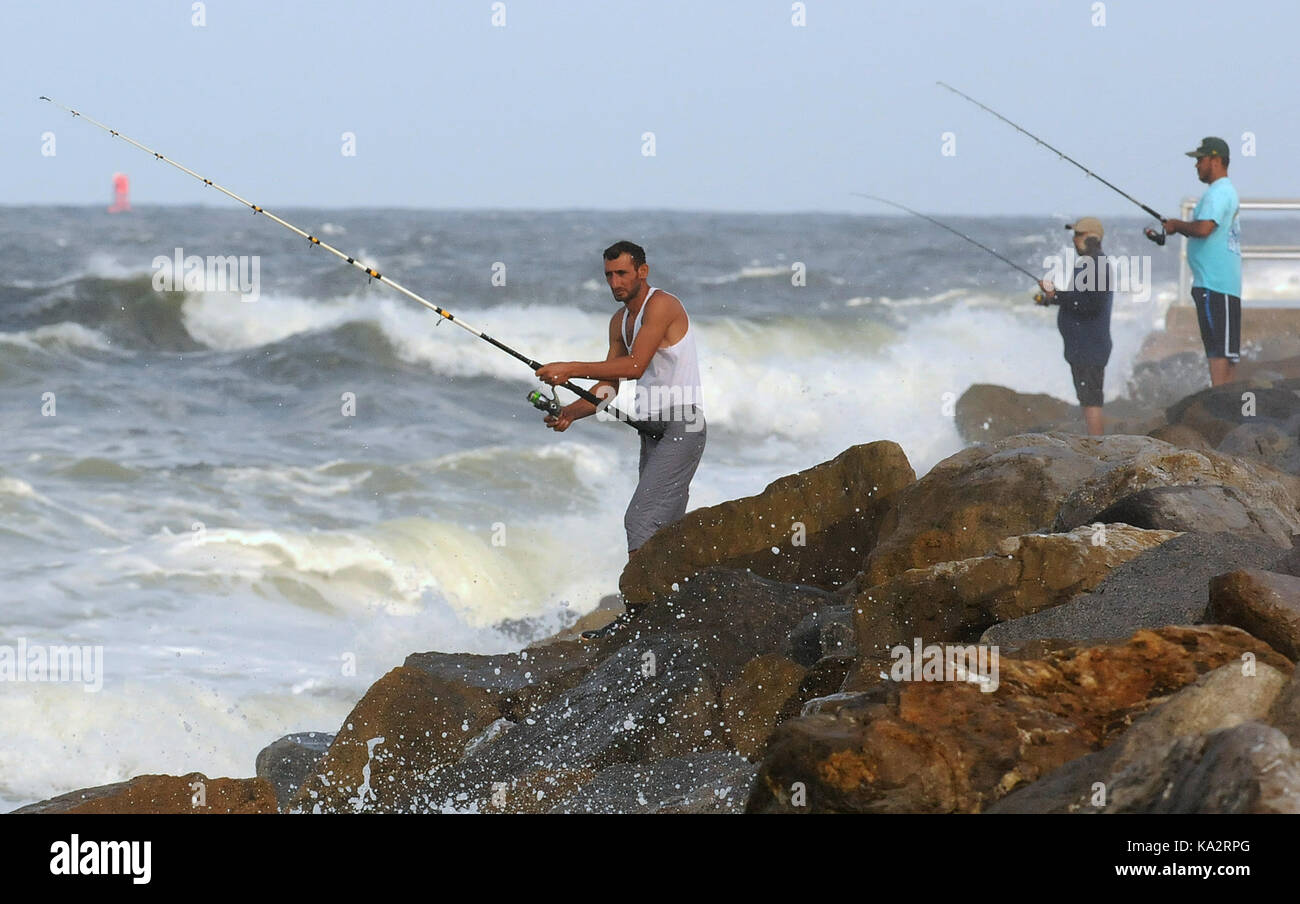 Ponce Inlet, United States. 24th Sep, 2017. Men fish from the jetty as