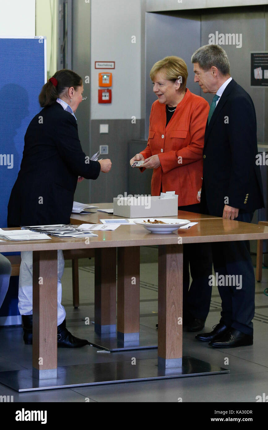 Berlin, Germany. 24th September, 2017. Chancellor Angela Merkel places a vote in general election for German Bundestag on September 24, 2014. She attended with her husband. Angela Merkel hopes to win the election and serve another term as Chancellor of the most powerful country in European Union. Credit: Dominika Zarzycka/Alamy Live News Stock Photo
