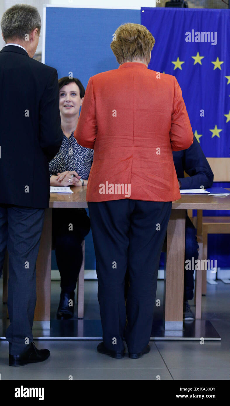 Berlin, Germany. 24th September, 2017. Chancellor Angela Merkel places a vote in general election for German Bundestag on September 24, 2014. She attended with her husband. Angela Merkel hopes to win the election and serve another term as Chancellor of the most powerful country in European Union. Credit: Dominika Zarzycka/Alamy Live News Stock Photo