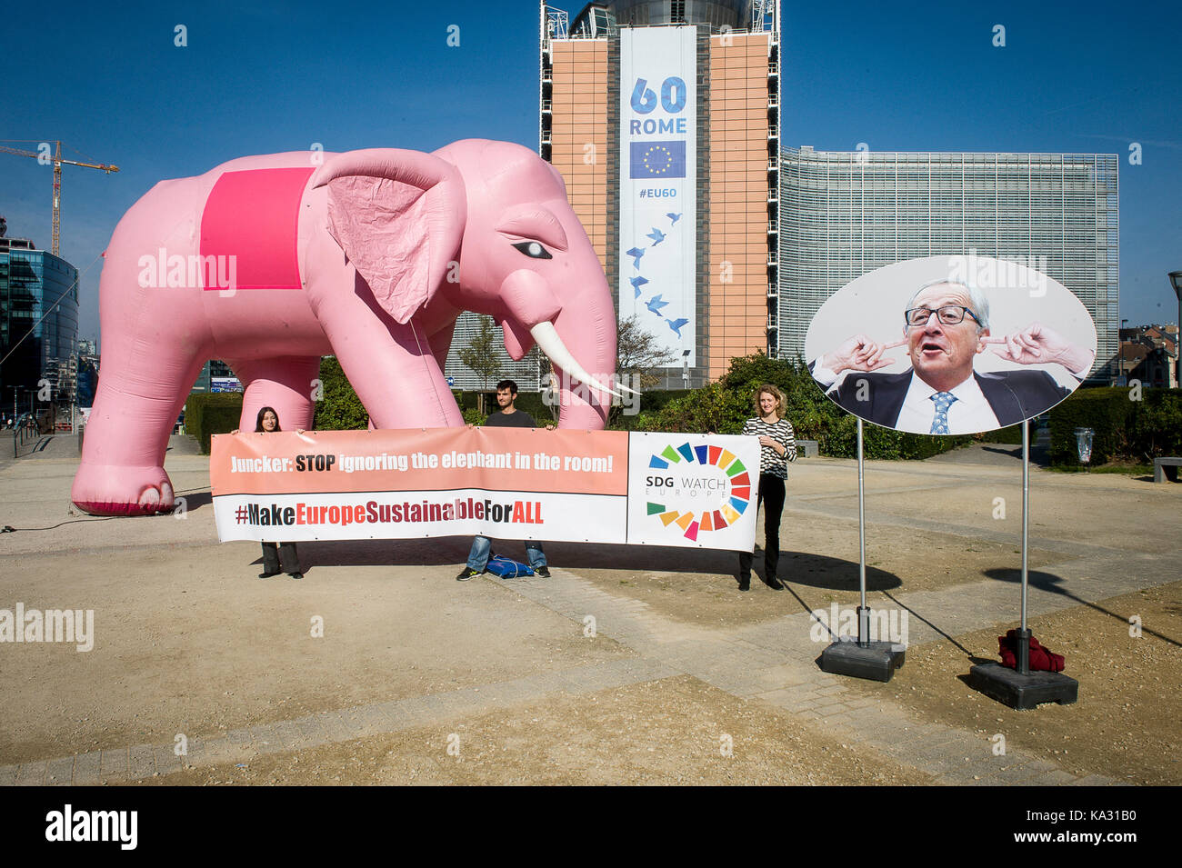 A massive inflatable elephant is seen in front of European Commission headquarters in Brussels, Belgium on 25.09.2017 SDG Watch protest at European quarters of Brussels to remind President Jean Claude Juncker, that he cannot continue to ignore sustainability. The protestors hold a banner with an inscription : 'Juncker stop ignoring elephant in the room' by Wiktor Dabkowski | usage worldwide Stock Photo
