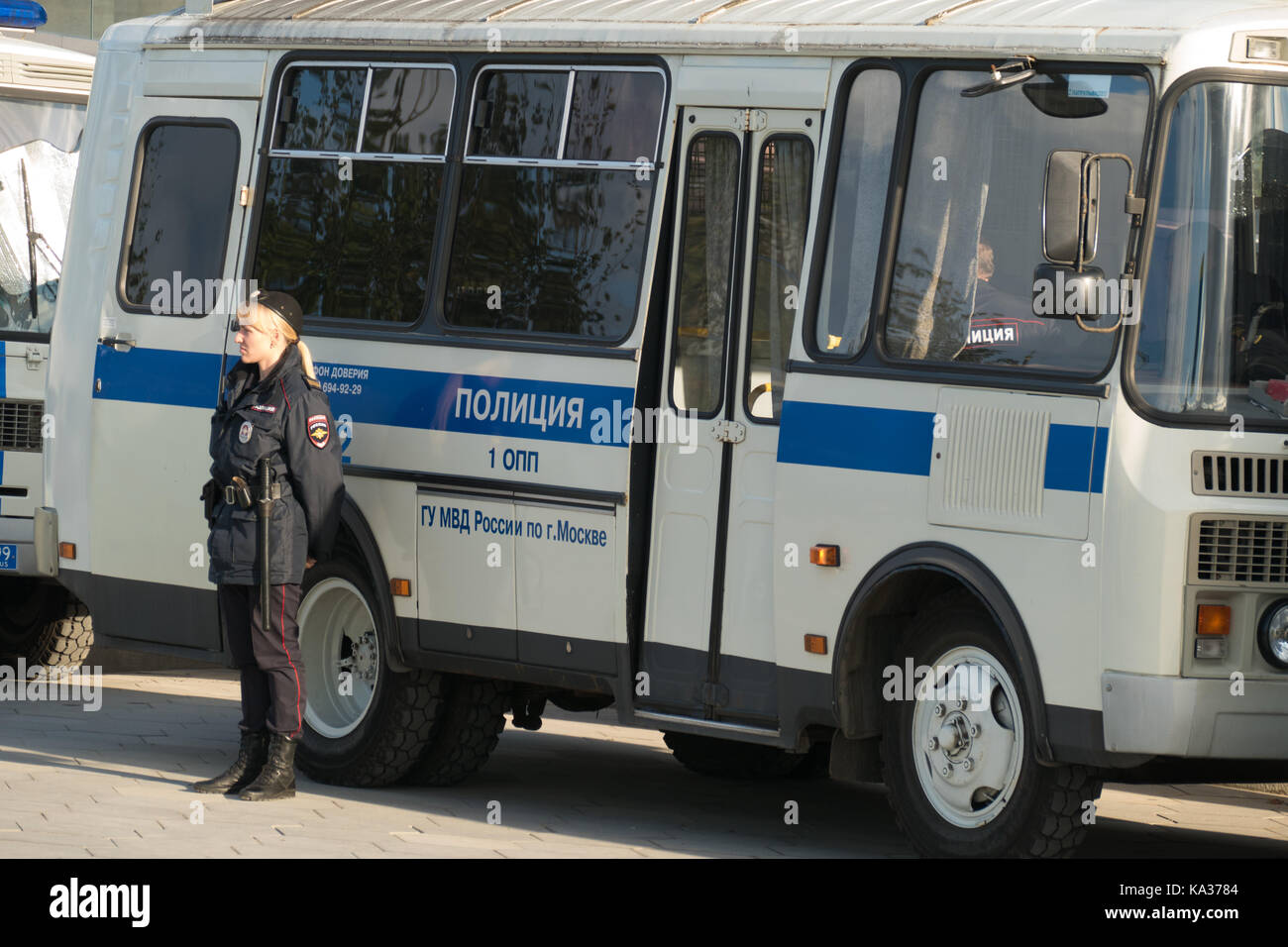police bus and lady police officer near Stock Photo