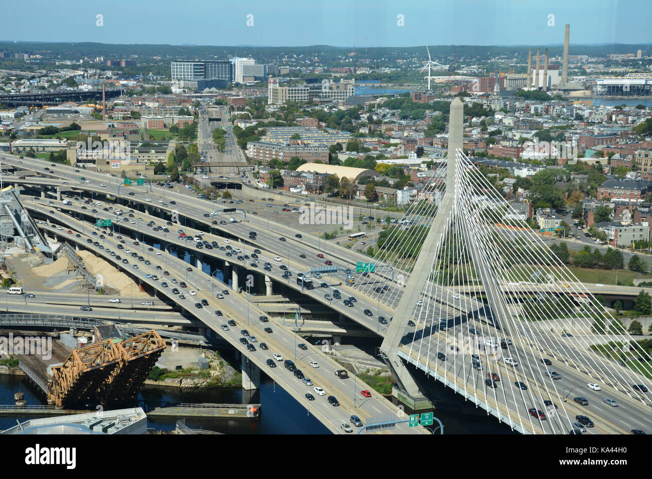 The Bunker Hill Memorial Leonard P. Zakim bridge in Boston, and points North seen from atop of a skyscraper in the West End on a sunny day. Stock Photo