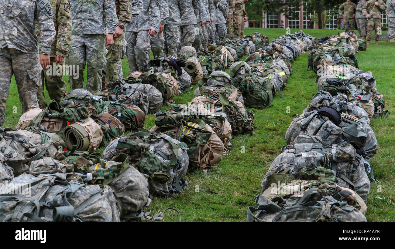 Soldiers marching by backpacks on grass Stock Photo Alamy
