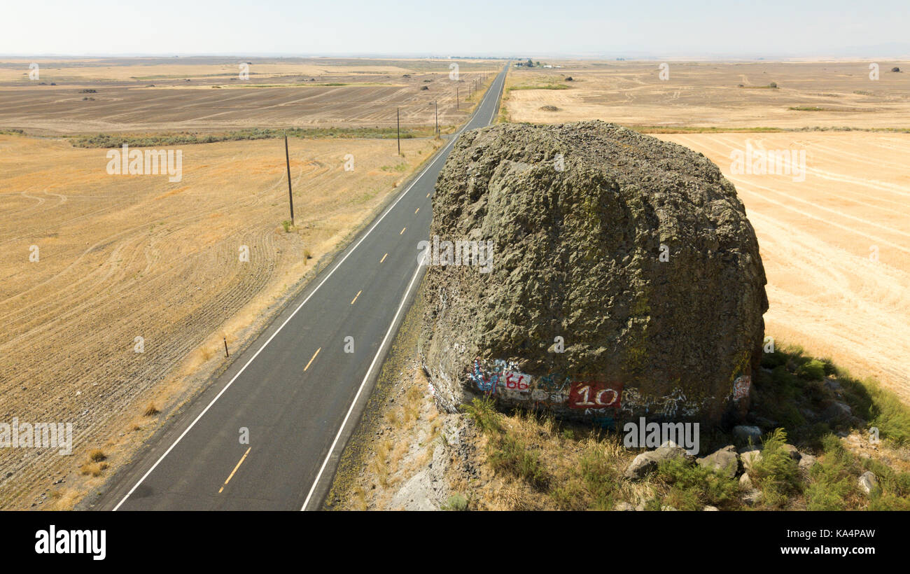 Yeager Rock, a large glacial erratic, lies along Hwy 172 near the town of Mansfield, Washington. Stock Photo