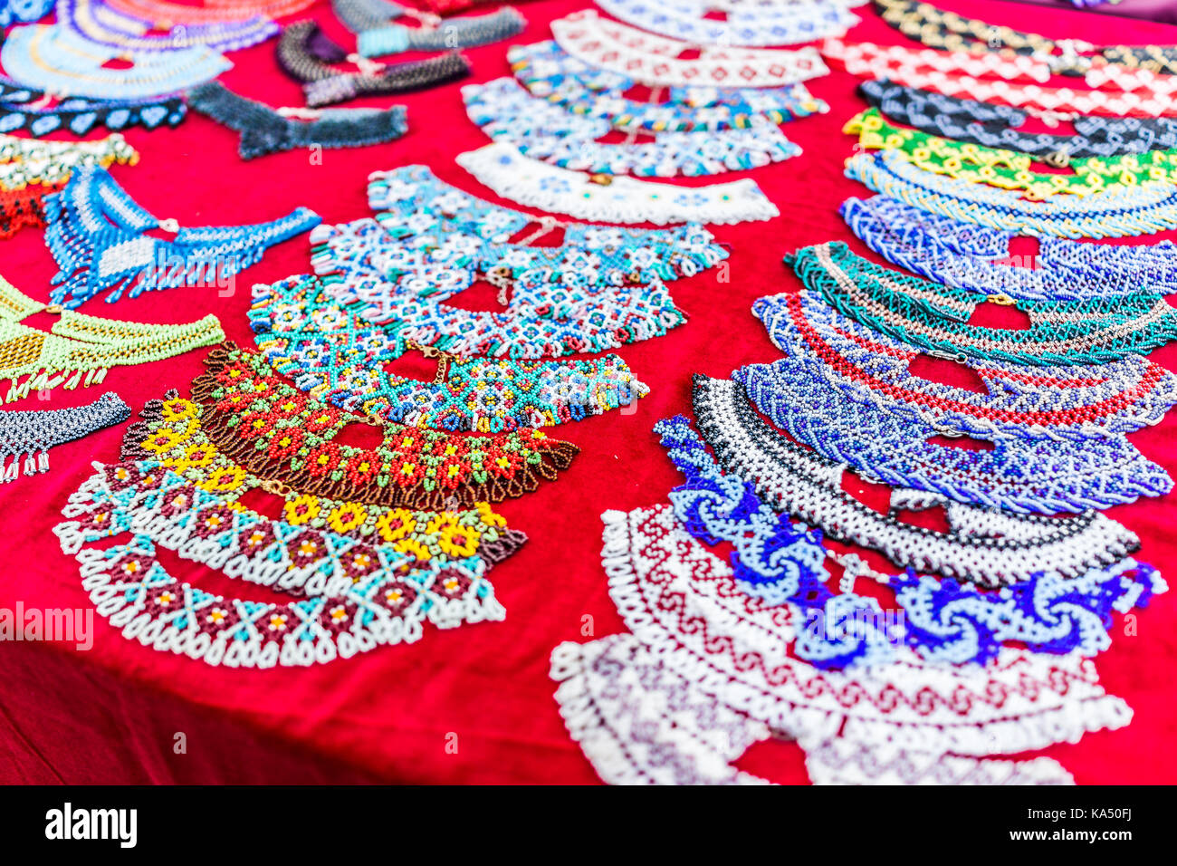 Closeup of beaded necklaces or bracelets made with traditional Ukrainian glass beads on table display in market, shop, store Stock Photo
