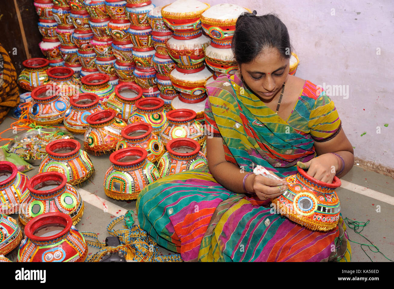 woman decorate Earthen Pot Garba Festival, Mumbai, maharashtra, India, Asia, MR#793B Stock Photo