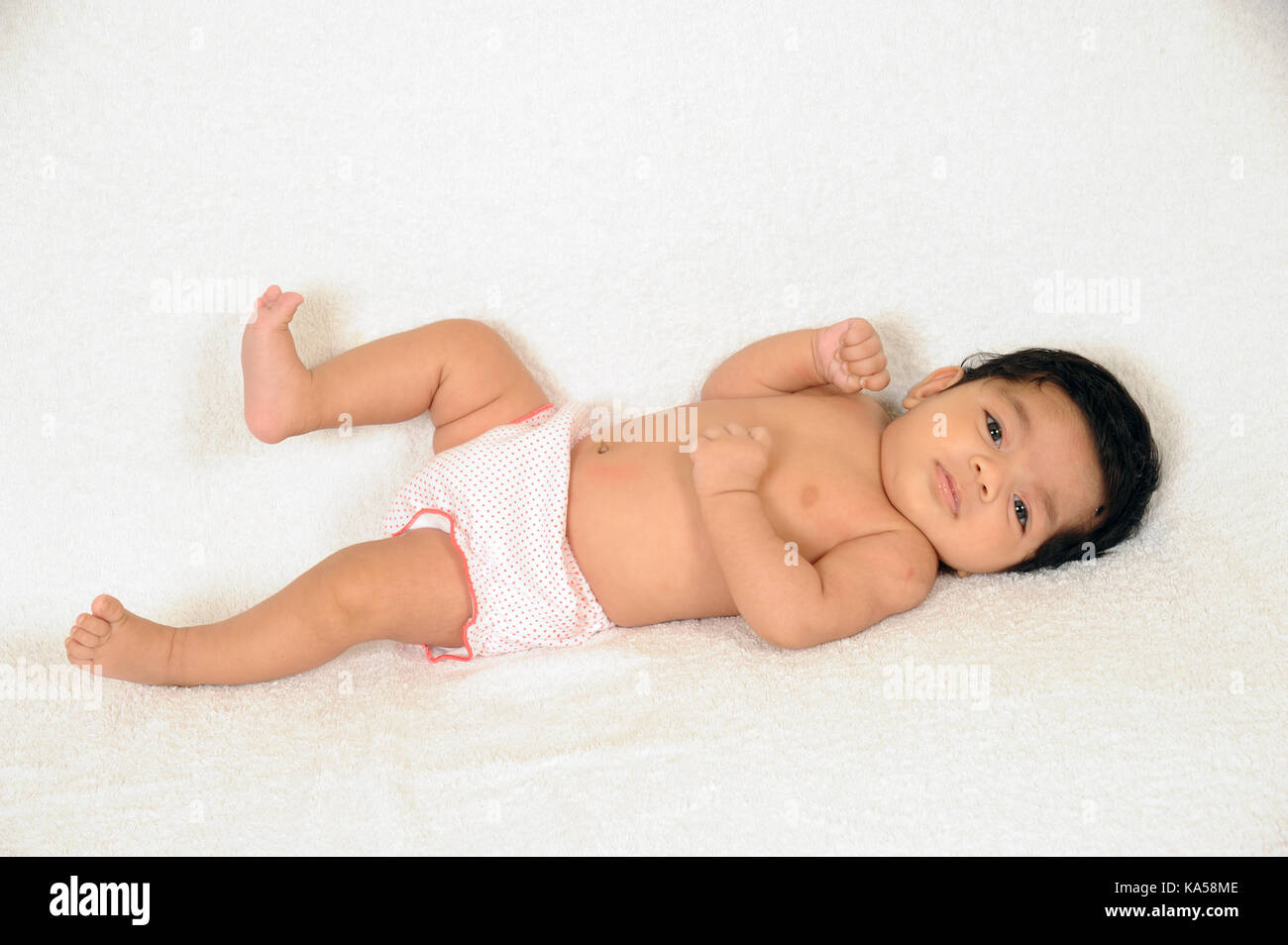 Two months old baby laying on white background , India, Asia MR#364 Stock Photo