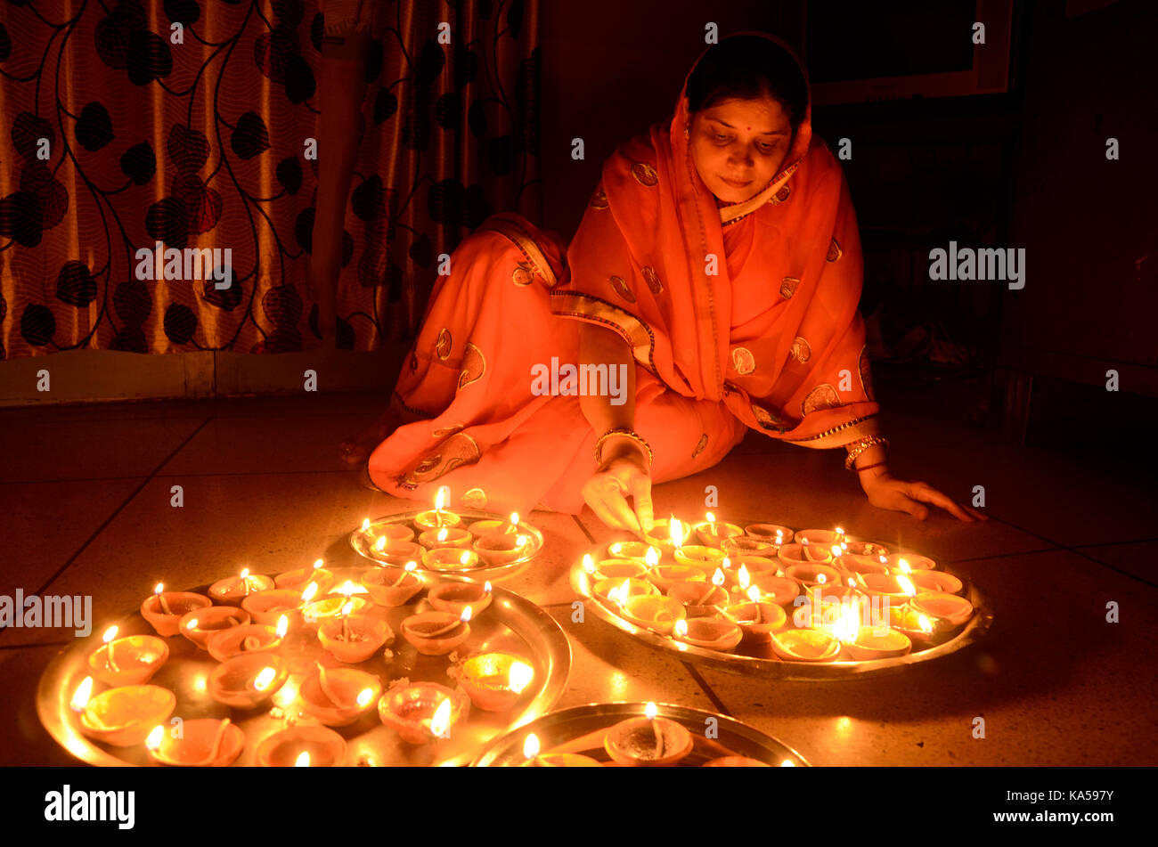 Indian woman lighting oil lamp hires stock photography and images Alamy