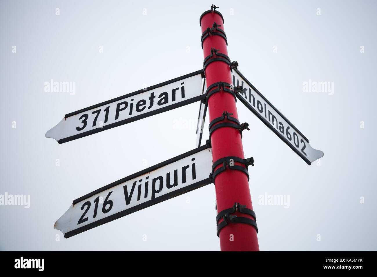 Red signpost, directional signs with distances to cities. Savonlinna, Finland Stock Photo