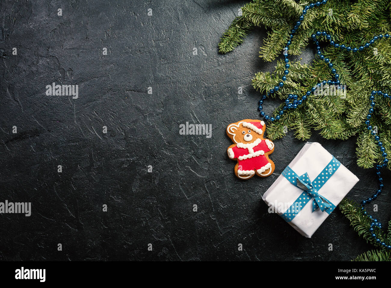 Christmas background with decorations, fir tree and gift boxes on black ...