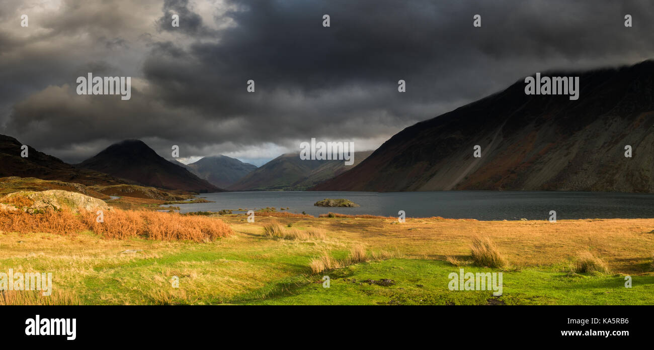 A shaft of light breaks through the clouds in Wasdale on a dark December day. Stock Photo