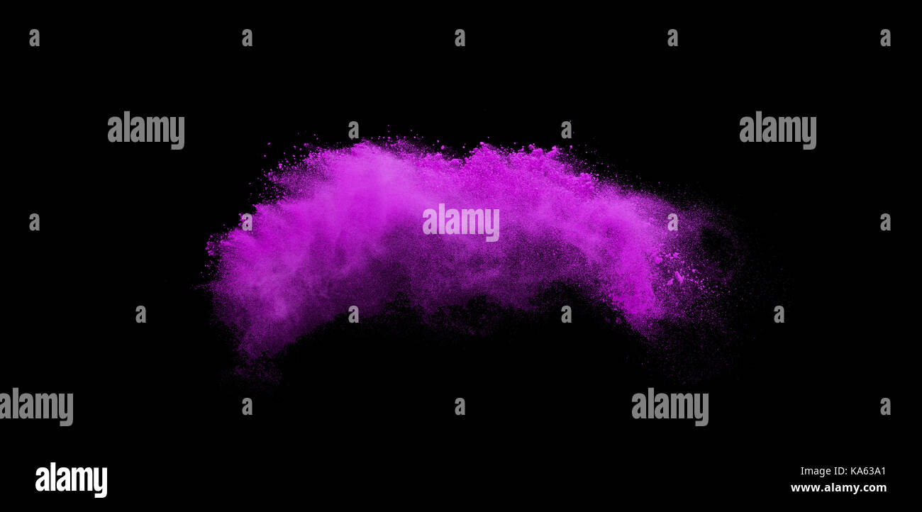 Powder explosion. Closeup of pink dust particle explosion isolated on background Stock Photo