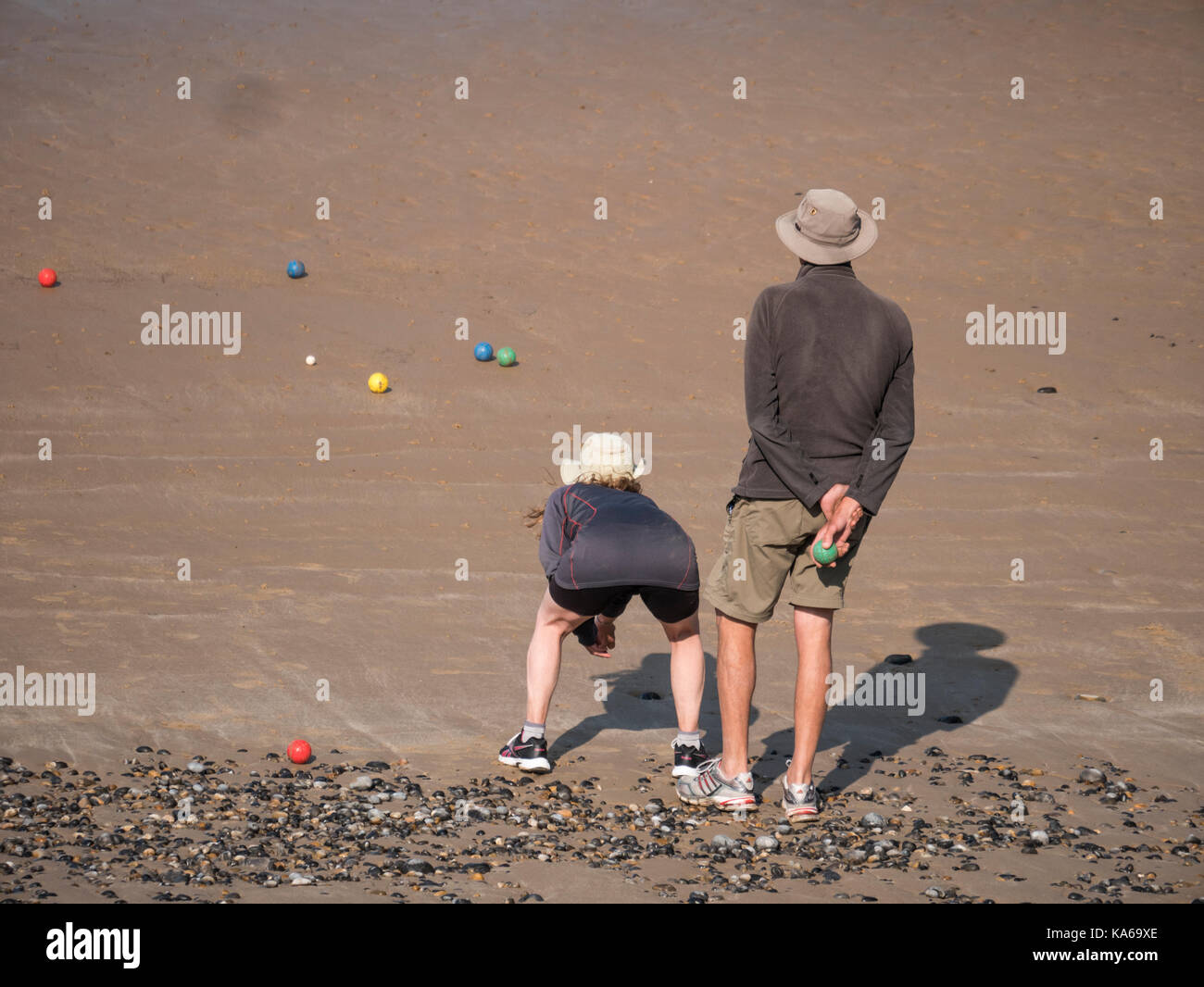 Couple playing bowls on the beach Stock Photo