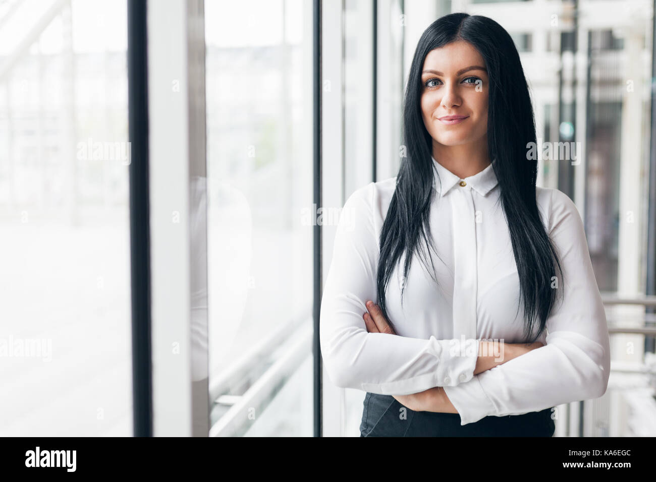Successful confident young business woman in an office setting Stock Photo