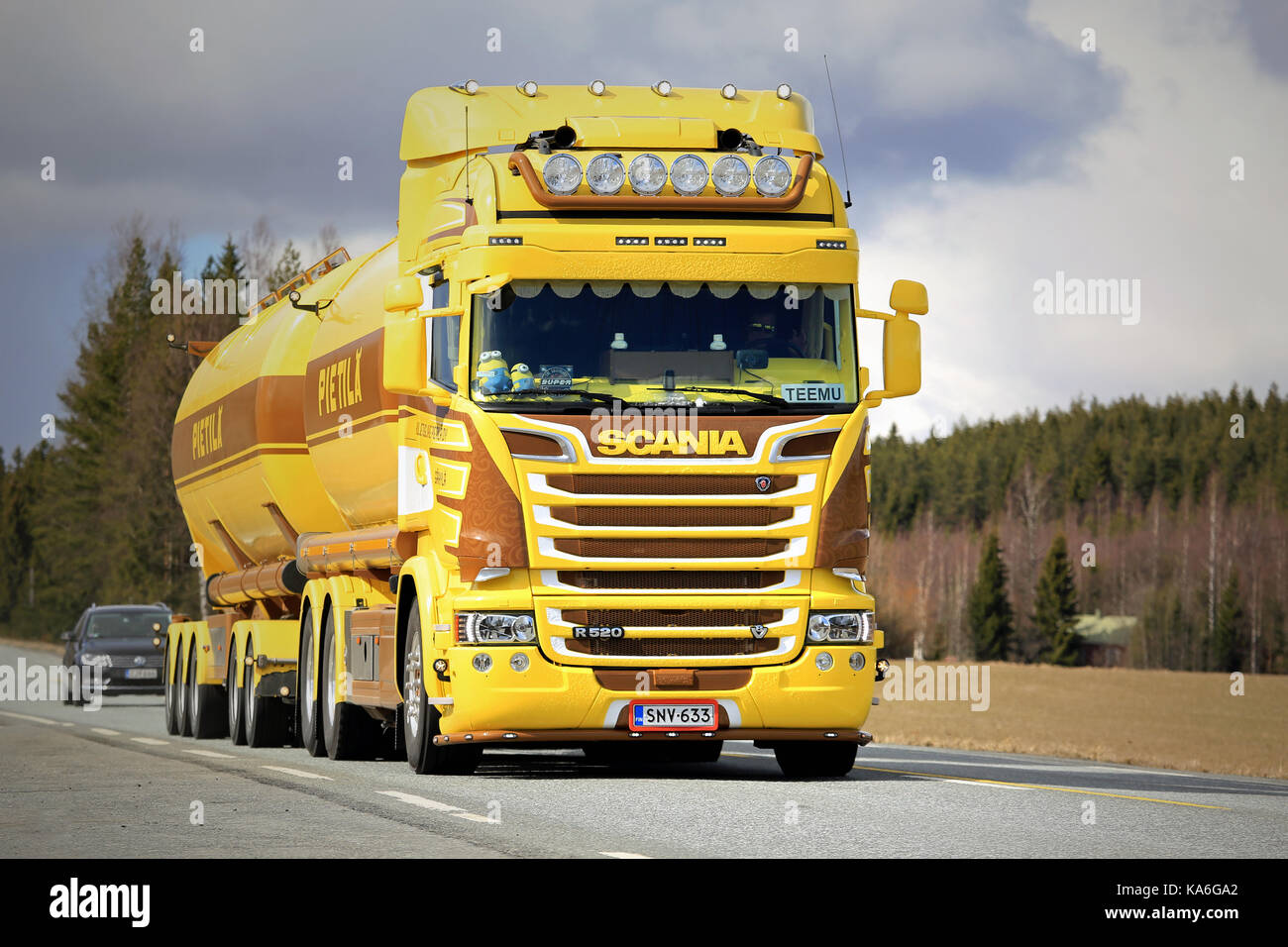JOKIOINEN, FINLAND - APRIL 23, 2017: Customized Scania R520 bulk transport truck of Kuljetusliike Pietila Oy of yellow and brown livery moves along hi Stock Photo