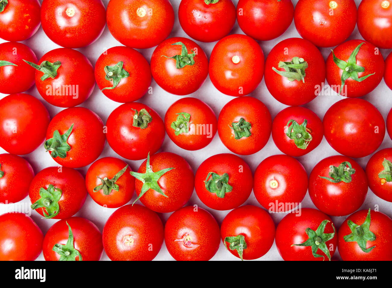 Bunch of whole cherry tomatoes forming background Stock Photo - Alamy